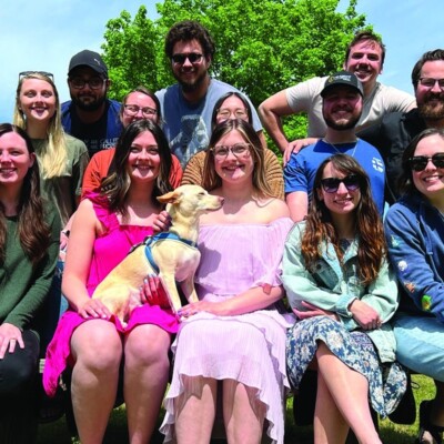 The Preckles, a Navigators family, stand next to the dozen young adults they are discipling at home.